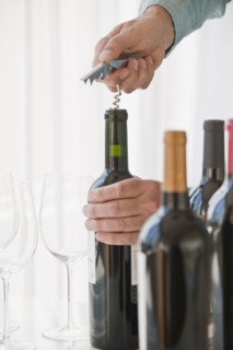 Uncorking wine.