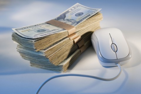 Computer mouse beside money.