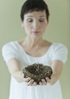 Woman holding nest.