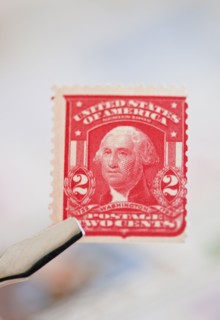 Tweezers holding stamp.