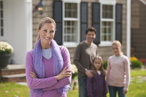 Family in front of house.