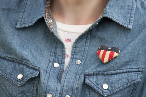 Woman wearing heart pin.