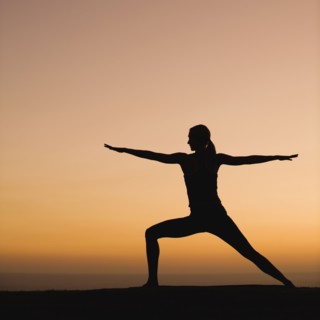 Silhouette of woman doing yoga