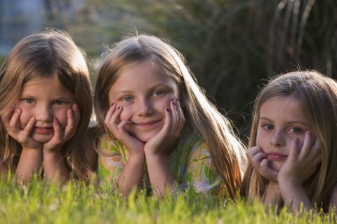 Young girls lying on grass