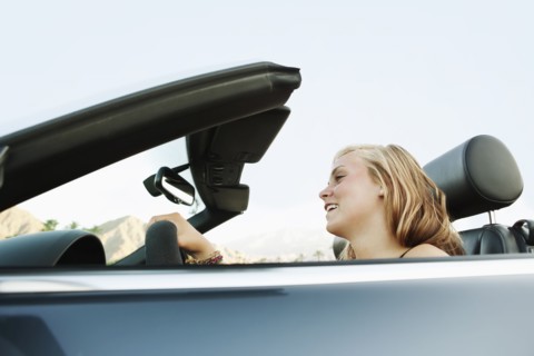 Woman driving convertible