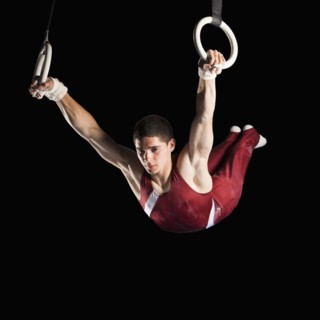 Gymnast swinging from rings