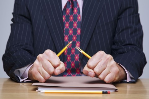 Man breaking pencil