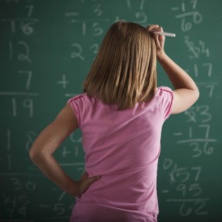 Student in front of chalkboard