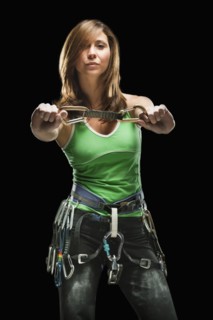 Studio shot of a female climber holding carabiners