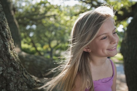 Girl beside tree