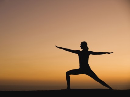 Silhouette of woman doing yoga