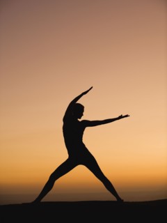 Silhouette of woman doing yoga
