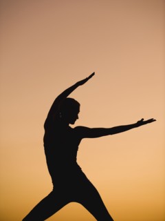 Silhouette of woman doing yoga