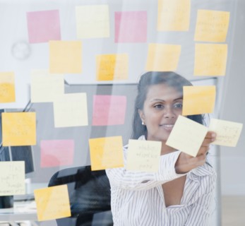 Woman looking at post-it notes