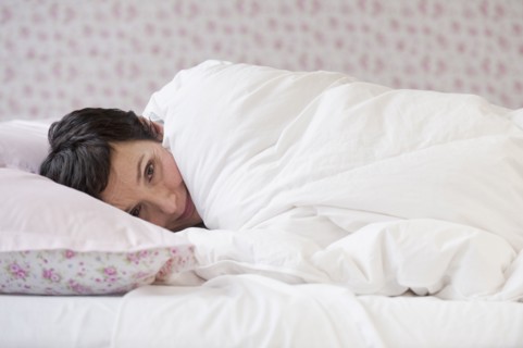 Woman lying in bed.