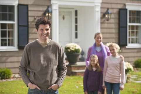Family in front of house.