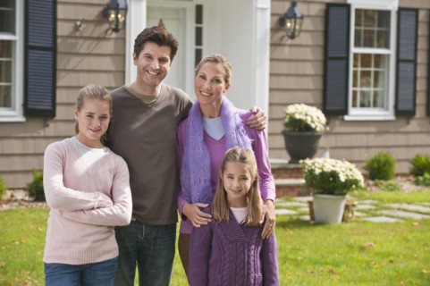 Family in front of house.