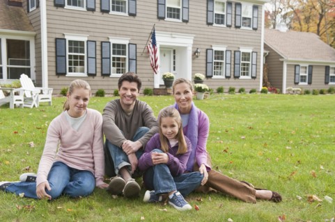 Family in front of house.