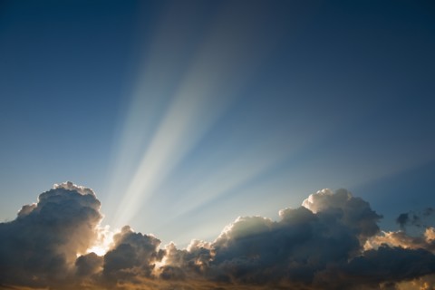 Sunset behind clouds.