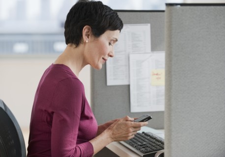 Businesswoman sitting at desk.