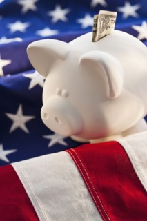 Piggybank on top of American flag.