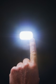 Finger pointing at light.