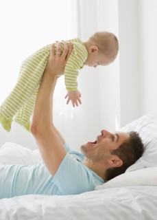 Father and baby playing.