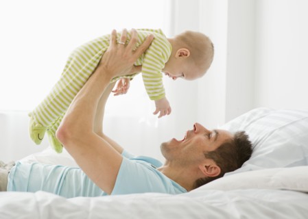 Father and baby playing.