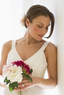 Bride holding bouquet of flowers.