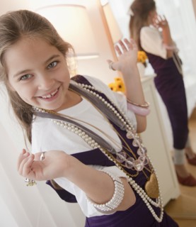 Young girl playing dress up. Photographer: Jamie Grill