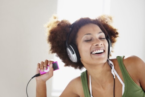 Woman listening to music. Photographer: momentimages