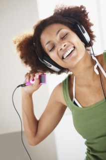 Woman listening to music. Photographer: momentimages