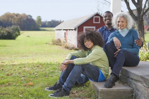 Family sitting on porch. Photographer: Pauline St.Denis