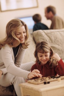 Mother and daughter playing checkers. Photographer: Rob Lewine