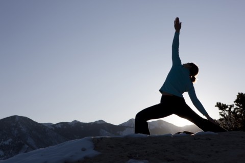 Woman doing yoga outdoors. Photographer: Dan Bannister