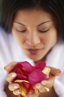 Woman holding flower petals. Photographer: Rob Lewine