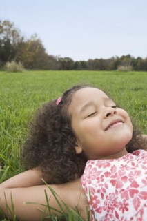 Girl lying on grass. Photographer: Pauline St.Denis