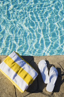 Flip flops and towel by the pool. Photographer: Chris Hackett
