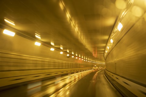 Cars driving in a tunnel. Photographer: fotog
