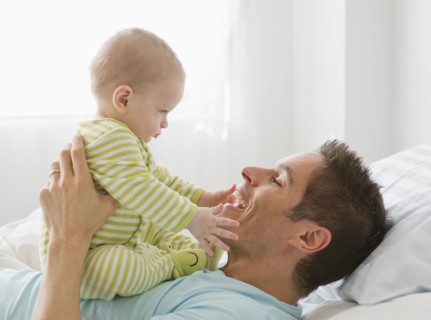 Father and baby playing.