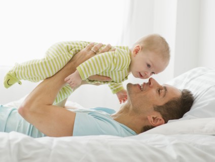 Father and baby playing.