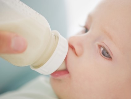 Baby drinking from bottle.