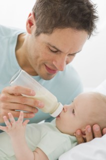 Father feeding baby.