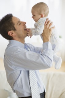 Businessman holding baby.
