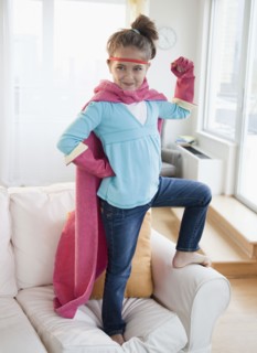 Young girl dressed up as a superhero. Photographer: Jamie Grill