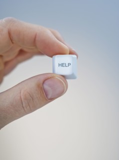 Hand holding keyboard help key.
