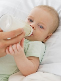 Baby drinking from bottle.