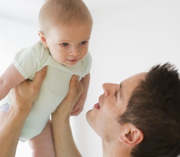 Father holding baby.