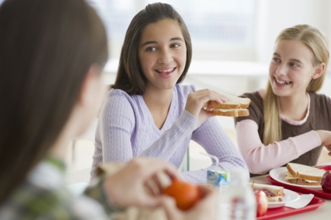 Friends eating in cafeteria.