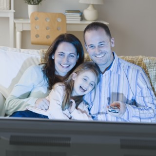 Family watching television. Photographer: Jamie Grill